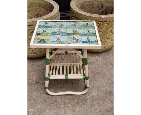 A decorative tile inset occasional table, 43cm wide. En suite with the previous lot. 