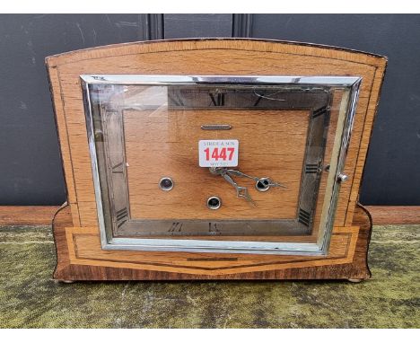 An Art Deco walnut and inlaid mantel clock, by Hendersons, 32cm wide. 