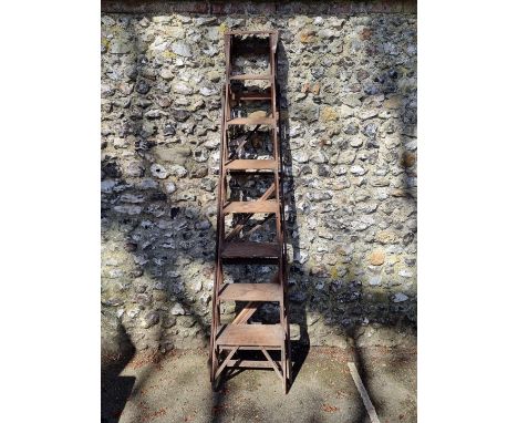 A large antique folding ladder. 