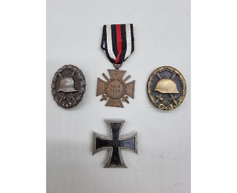 A World War I Iron Cross first class, together with a Combatants Cross with swords; a World War I Wound badge; and a World Wa
