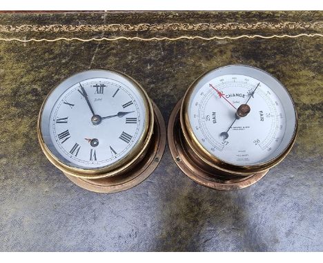 A Sestrel brass bulkhead clock and barometer set,&nbsp;13cm diameter.&nbsp; 