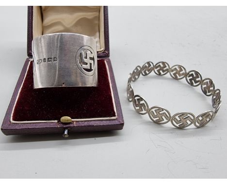 A boxed silver napkin ring, with swastika motif by Mappin &amp; Webb, hallmarked 1922; together with a silver bangle of simil