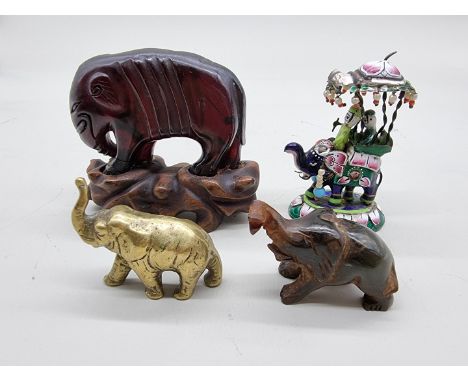Four model elephants,&nbsp;comprising: an Indian enamel example, 7.5cm high; a small brass example; and two horn examples, la