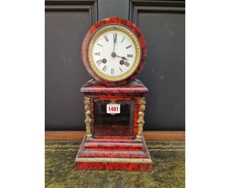 A late 19th century red tortoiseshell and brass mounted mantel clock,&nbsp;34cm high, with pendulum. 