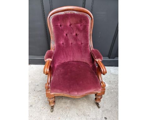 A Victorian mahogany and button upholstered open arm occasional chair.&nbsp; 