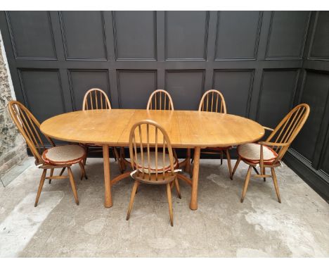 An Ercol drawleaf dining table and set of six chairs, to include a pair of elbow chairs, the table 220cm extended. 