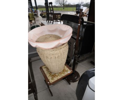 Wooden standard lamp with shade, wicker laundry basket and small tile topped table