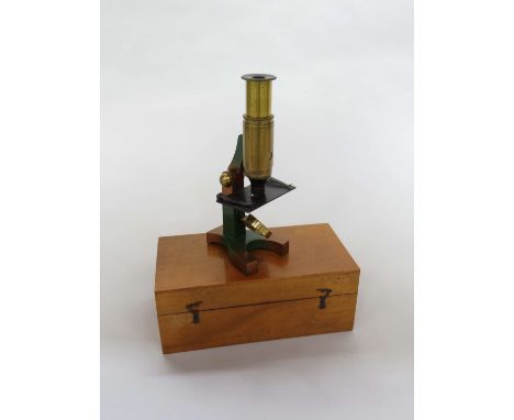 An early 20th Century compact brass monocular field microscope, adjustable tube, single lens, case marked Rowley & Son Optici