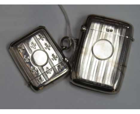 A George V silver vesta case of vertical rectangular form with striped engine-turned decoration around a vacant circular cart