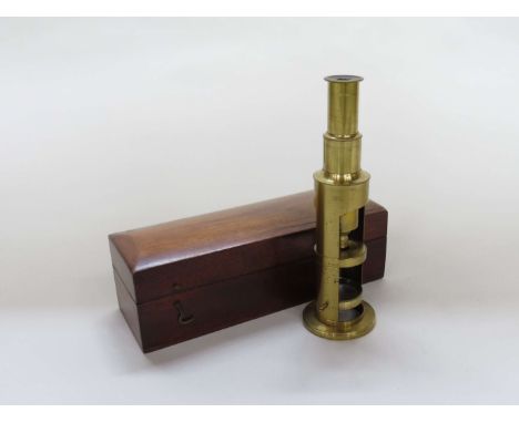 A late 19th/early 20th Century compact brass monocular field microscope of telescope form adjustable tube, single lens, mahog