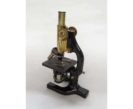 A mid 20th Century Reichert of Austria monocular microscope No.87399 with 9x and 5x eye pieces and multiple objective lenses,