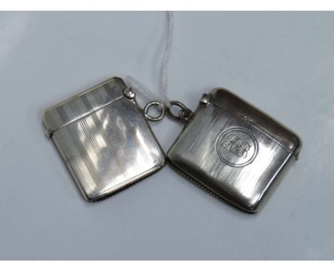 Two similar George V silver vesta cases decorated with striped engine-turned decoration, one engraved with an owl, the other 