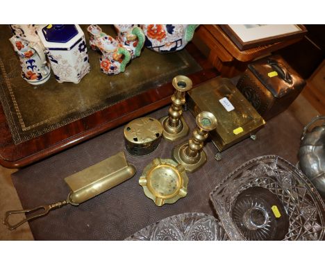 A pair of Victorian brass candlesticks, an ash scoop, a brass cigarette box, tea caddy etc.