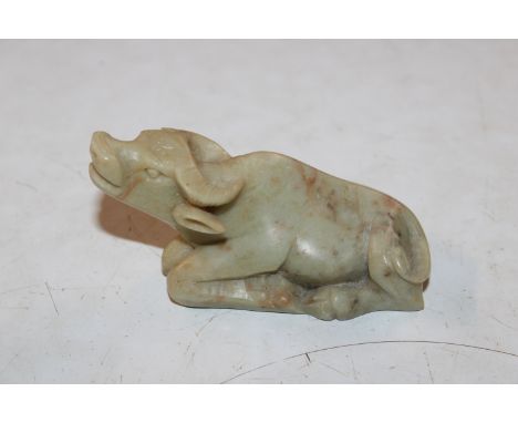 A hand carved Celadon jade coloured model of a water buffalo