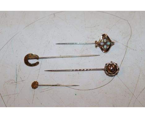 A yellow metal and opal set Charles Horner style stick pin; a yellow metal stick pin mounted with a horseshoe and two other y