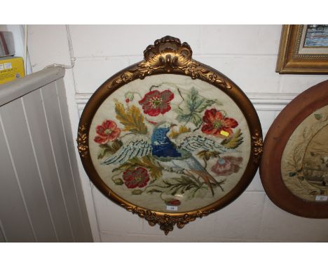 A late Victorian tapestry picture of a parrot amongst foliage in decorative gilt frame 