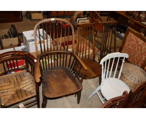 An elm seated stick back Windsor chair; and two other stick back chairs 
