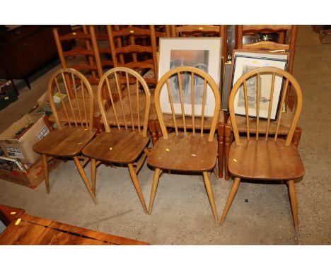 A set of four Ercol stick back dining chairs 