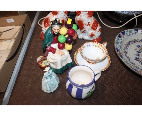 A Royal Doulton figure "The Old Balloon Seller" HN1315; a small Coalport figurine; a Whittard cup and saucer; and a Hudson's 