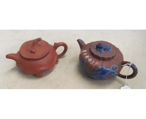A Yxing terracotta teapot with frog to lid and another with blue enamel decoration