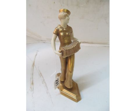 A Royal Dux lady accordion player in gilt sailor costume