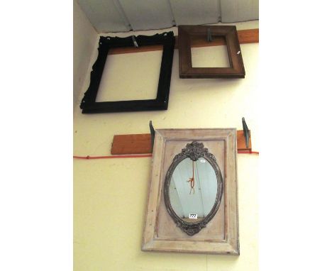 A white painted framed mirror and two picture frames
