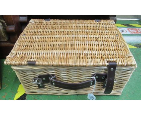 A picnic basket, a shooting stick and a pair of brass candlesticks