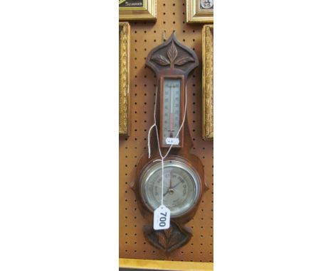 An oak cased barometer/thermometer