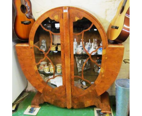 An Art Deco walnut cabinet of circular form on bracket feet