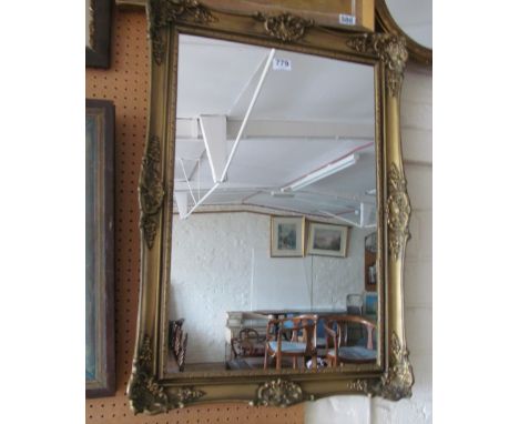 A gilt framed mirror with shell design