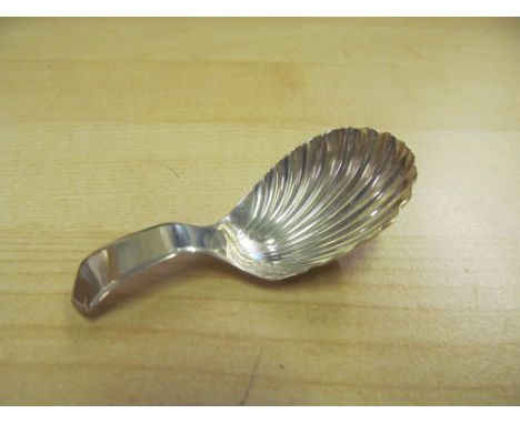 A silver caddy spoon