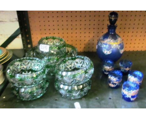 A set of green flashed glass bowl and six sundae dishes and a Venetian blue and floral glass liqueur set (five glasses)