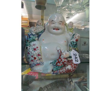 A Chinese Buddha figure surrounded by boysslight line on big toe showing under blue light