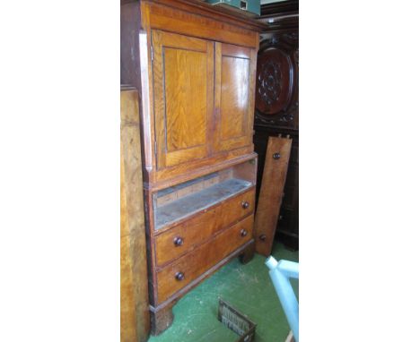 A 19th Century oak linenpress two cupboards doors over three drawers on bracket feet, secretaire drawer which need hinges red