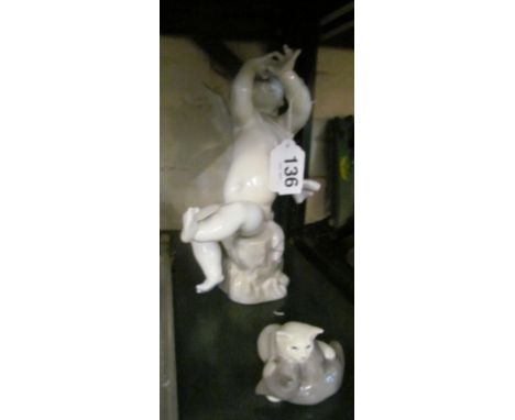 A Lladro figure angel playing a pipe (pipe a/f) and two Royal Copenhagen cats playing