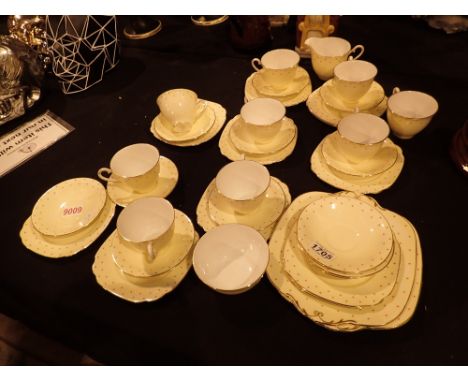 Large quantity of Windsor bone china teaware pale yellow with raised orange dots to rim  CONDITION REPORT: two cups have hair