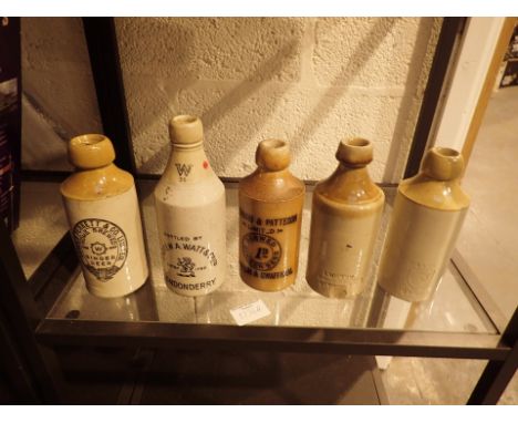 Five vintage stoneware bottles including Londonderry example