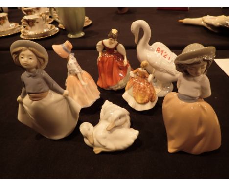 Four Nao figurines and three Royal Doulton lady figurines