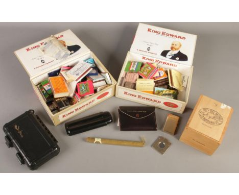 A quantity of smoking related items. Includes Donatus cigar cutter, Mistral lighter, cigar caddy, matchboxes, etc.  
