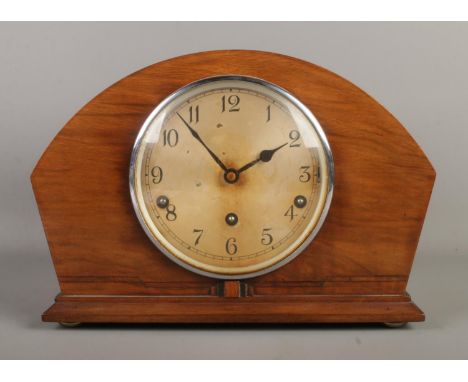 A mahogany Art Deco Garrard dome top mantle clock, with Arabic Numeral dial.  Key and pendulum present.
