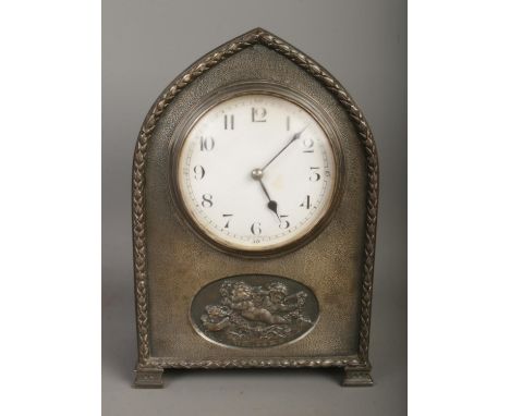 A French white metal presentation mantel clock featuring cherub motif with French movement. Presentation plaque reads "Presen