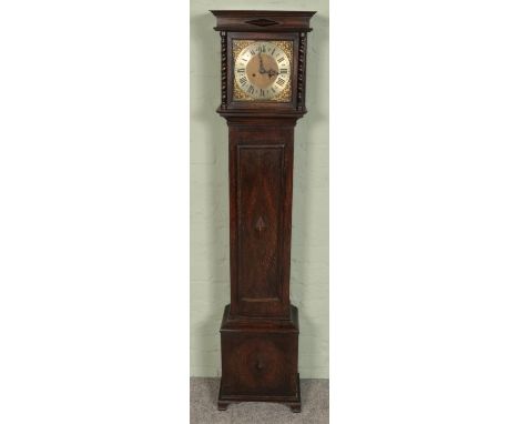 A John Mason of Rotherham oak granddaughter clock decorated with cherub scrollwork motifs and roman numeral dial. Movement st