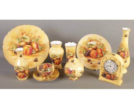 A small collection of Aynsley Orchard Gold ceramics. Includes mantel clock, bud vase, plates, teacup &amp; saucer, etc.  