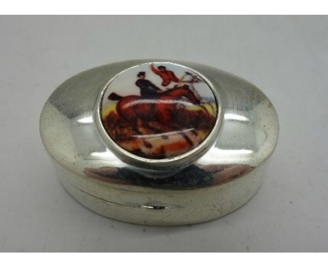 A modern silver pill box with hunting scene