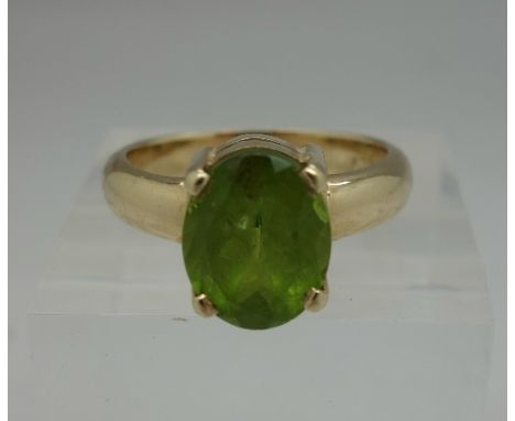 A yellow metal and peridot ring, 9ct engraved on shank, weight 6.5g, size R
