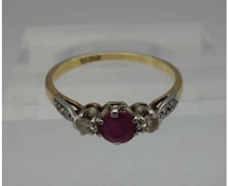 An 18ct gold ruby and white stone ring, weight 1.7g, size L