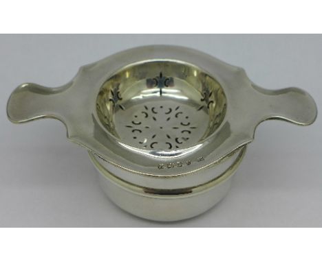A silver bowl and a silver strainer, Sheffield 1936 and Birmingham 1919, weight 70g