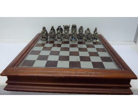 A Lord of The Rings chess set with board/box by Danbury Mint, heavy hand-cast pieces