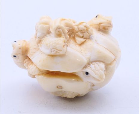 A bone netsuke carving in the form of frogs signed with three characters.  4.5 x 3.5 cm. 