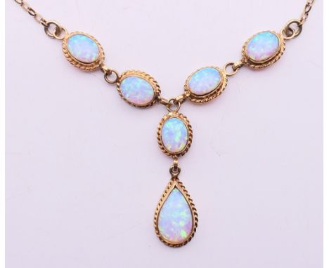 A 9 ct gold opal pendant necklace.  Necklace 40 cm long, pendant drop 2 cm high including suspension loop, other opal drops e